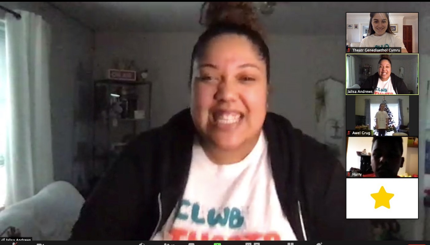 4.	Screenshot of a Zoom call. A young woman is staring at the camera she is smiling with her mouth open and her teeth are showing. On the side we can see 5 other participants, 4 have their cameras on.