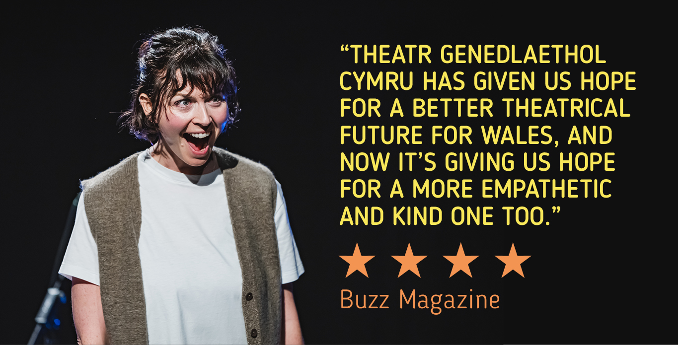 Production image from Ie Ie Ie, featuring a person grinning. A quote is overlaid saying: "Theatr Genedlaethol Cymru has given us hope for a better theatrical future for Wales, and now it's giving us hope for a more empathetic and kind one too."