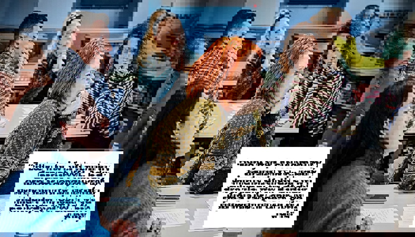 Groups of people sat around two tables. They are looking off camera. One woman is very much in focus, and she is smiling. There are pieces of paper, pens and coffee cups on the table in front of them. Text on image reads "Thank you very much as a company for the GREAT provision.... The day was so useful and I'm really looking forward to bringing these ideas to the classroom - with every year, not just GCSE and A Level